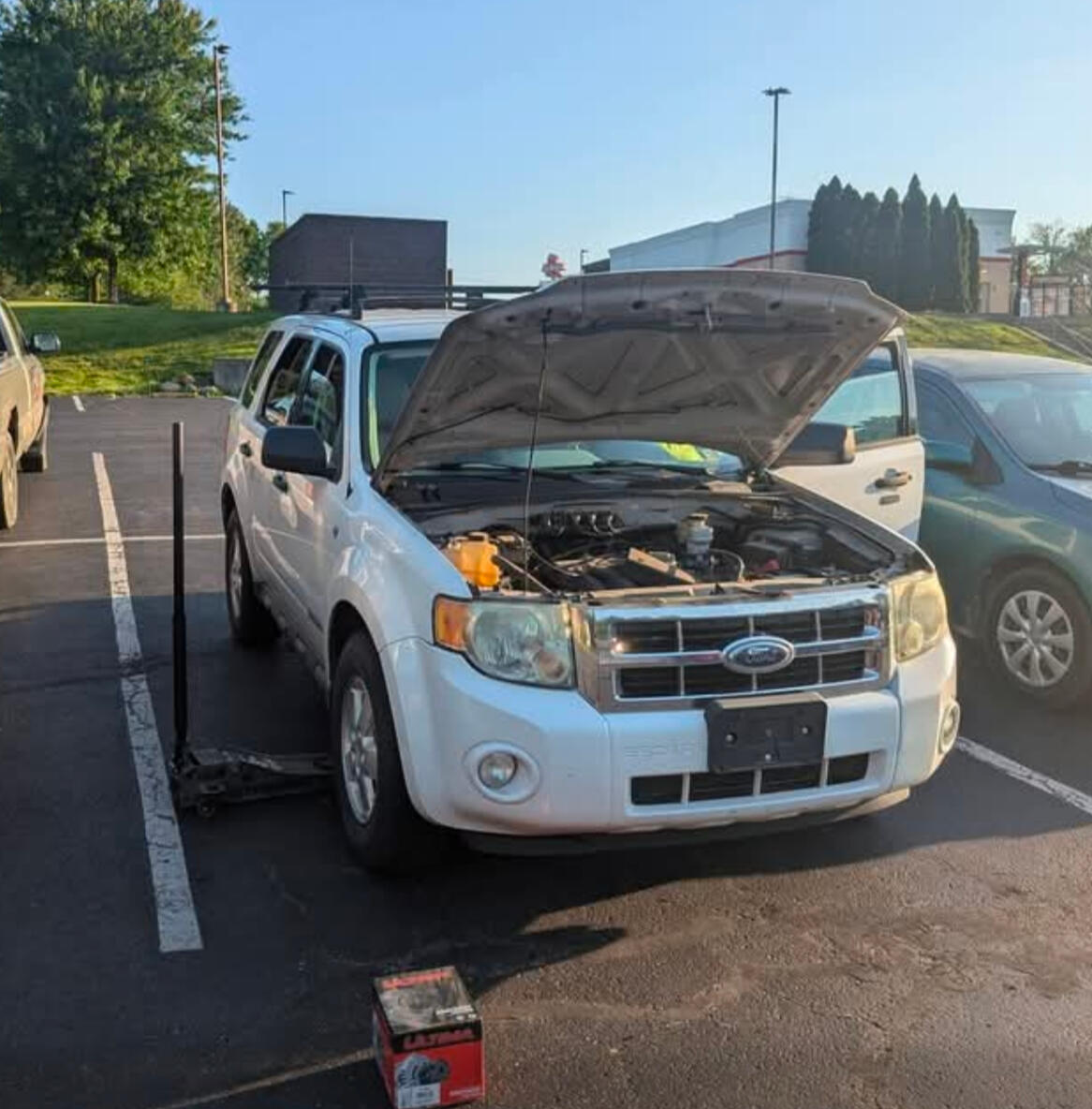 Mobile Service At Your Location Mobile mechanic performing alternator replacement on a Ford Escape in a parking lot in Fort Worth TX